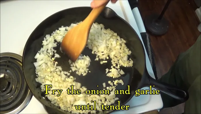 Fry onions and garlic in a cast iron skillet until tender (131.87). Add shredded chicken and mix (141.94).